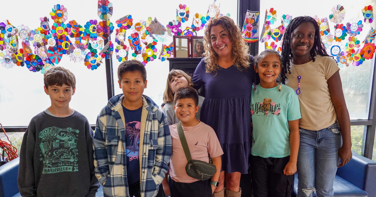 genton and students in front of mural
